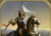 Św. Ludwik IX: król, który połączył wiarę, rodzinę i służbę ubogim Obraz olejny Émile'a Signola: św. Ludwik IX w koronie i złocistej zbroi na siwym koniu, z uniesionym mieczem i chorągwią z liliami, na morskim brzegu.