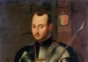 Święty Ignacy Loyola: od pychy żołnierza do założenia Wojska Jezusowego Portret św. Ignacego Loyoli w pełnej zbroi rycerskiej, z drzewcem włóczni w ręku i herbem rodu Loyola w tle