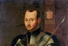 Święty Ignacy Loyola: od pychy żołnierza do założenia Wojska Jezusowego Portret św. Ignacego Loyoli w pełnej zbroi rycerskiej, z drzewcem włóczni w ręku i herbem rodu Loyola w tle