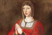 Kastylia i León popiera beatyfikację Izabeli Katolickiej i współpracę z Kościołem Historyczny portret królowej Izabeli I Katolickiej w czerwonej szacie i welonie, z dłońmi złożonymi do modlitwy, na ciemnym tle. Malowidło nieznanego autora.
